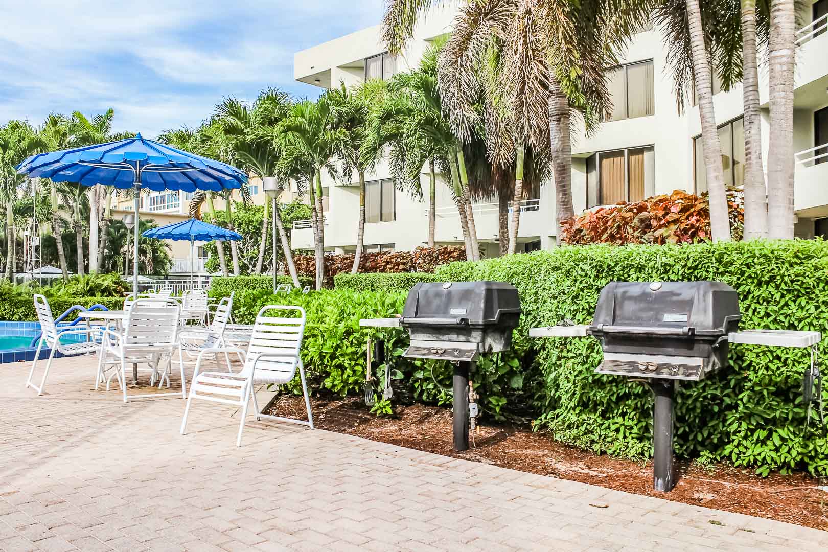 A pleasant pool area with BBQ Grills at VRI's Berkshire by the Sea in Florida.